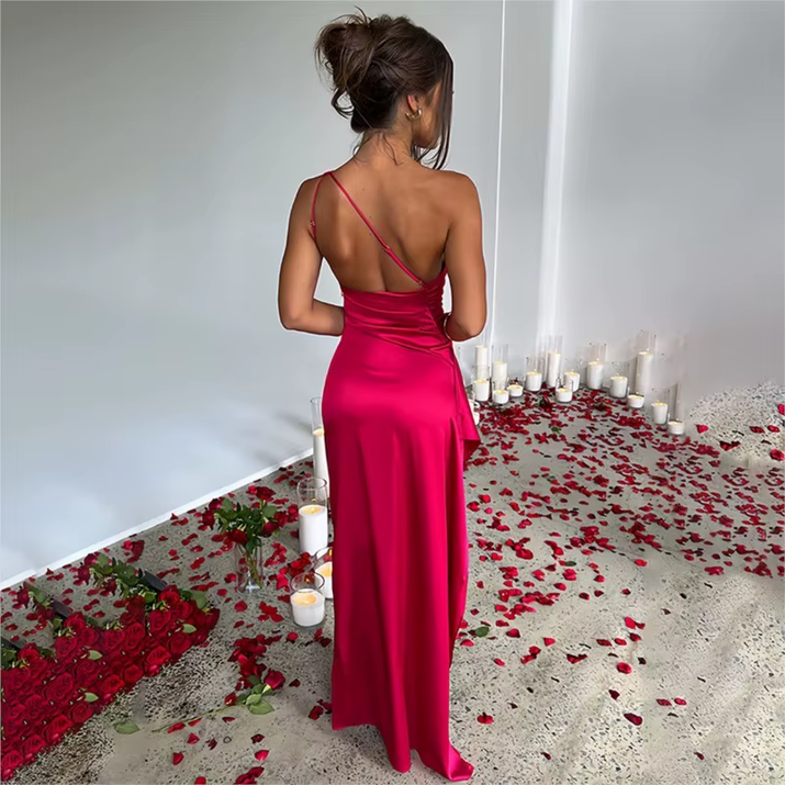 Exude timeless sophistication in this one-shoulder satin gown, designed for summer soirées and evening elegance. Featuring a sleeveless silhouette, daring high slit, and alluring backless detail, this dress is the epitome of graceful allure—perfect for cocktail parties, formal gatherings, or any occasion where elegance is essential